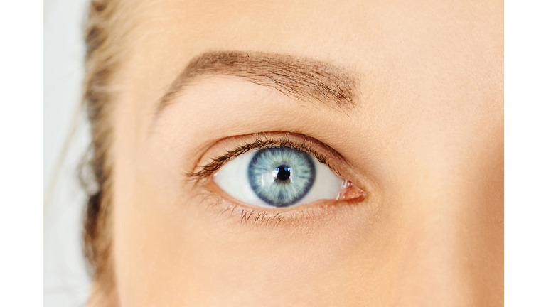 Close-up of female blue eye without make-up