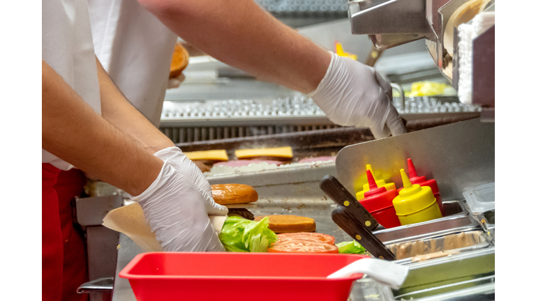 Fast food workers working in a hamburger restaurant