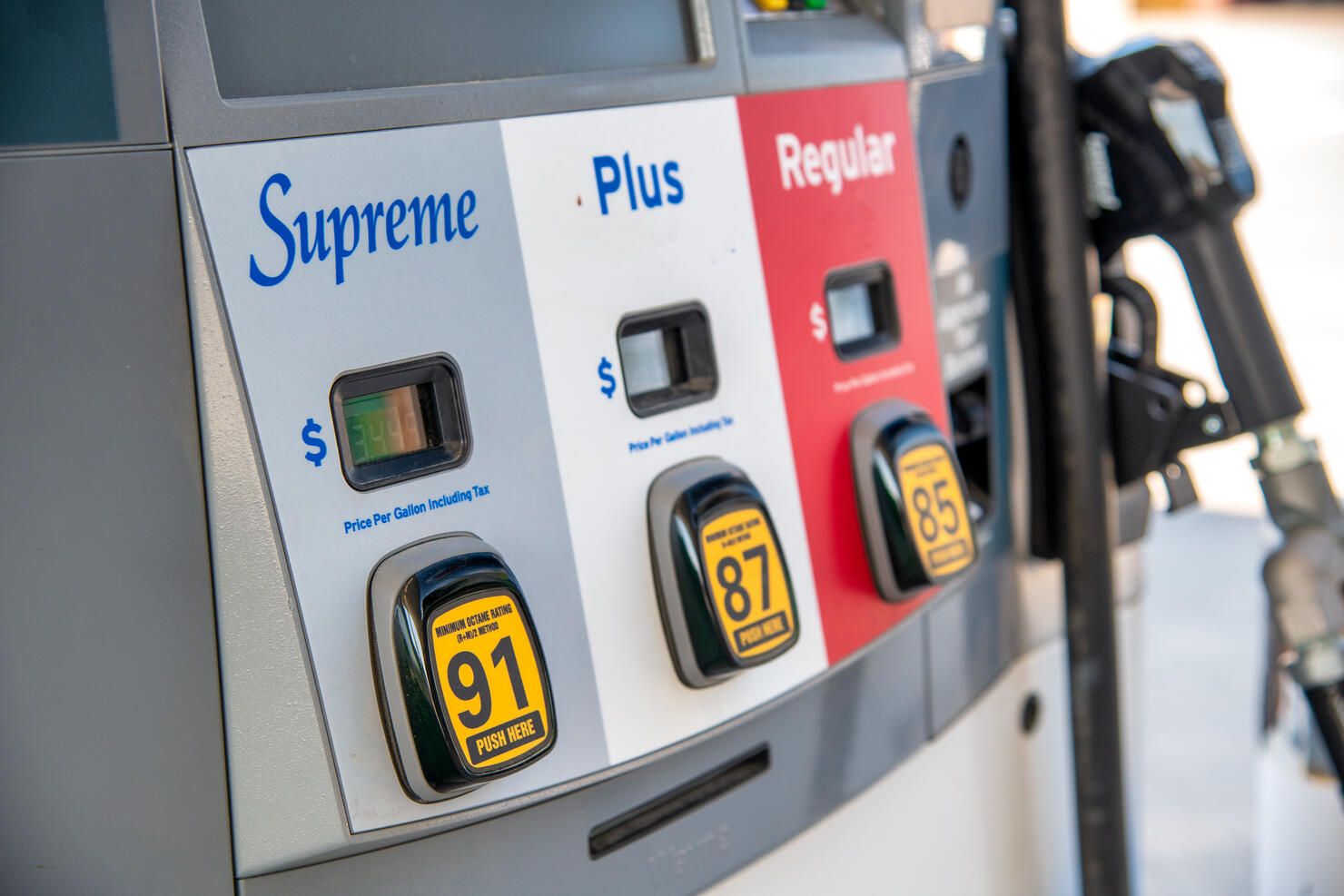 Supreme, Plus, Regular gasoline at gas station pump.