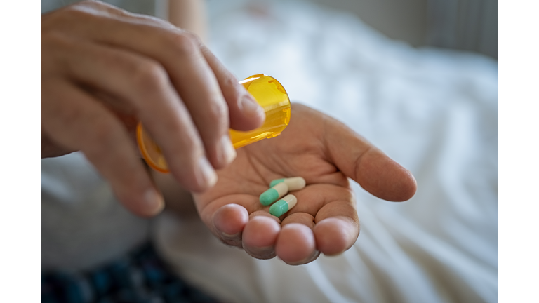 Man hand taking medicine