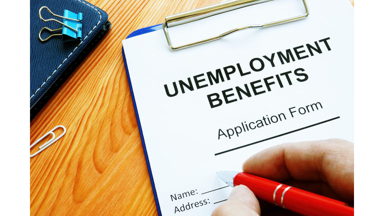 Man fills in Unemployment benefits application form.