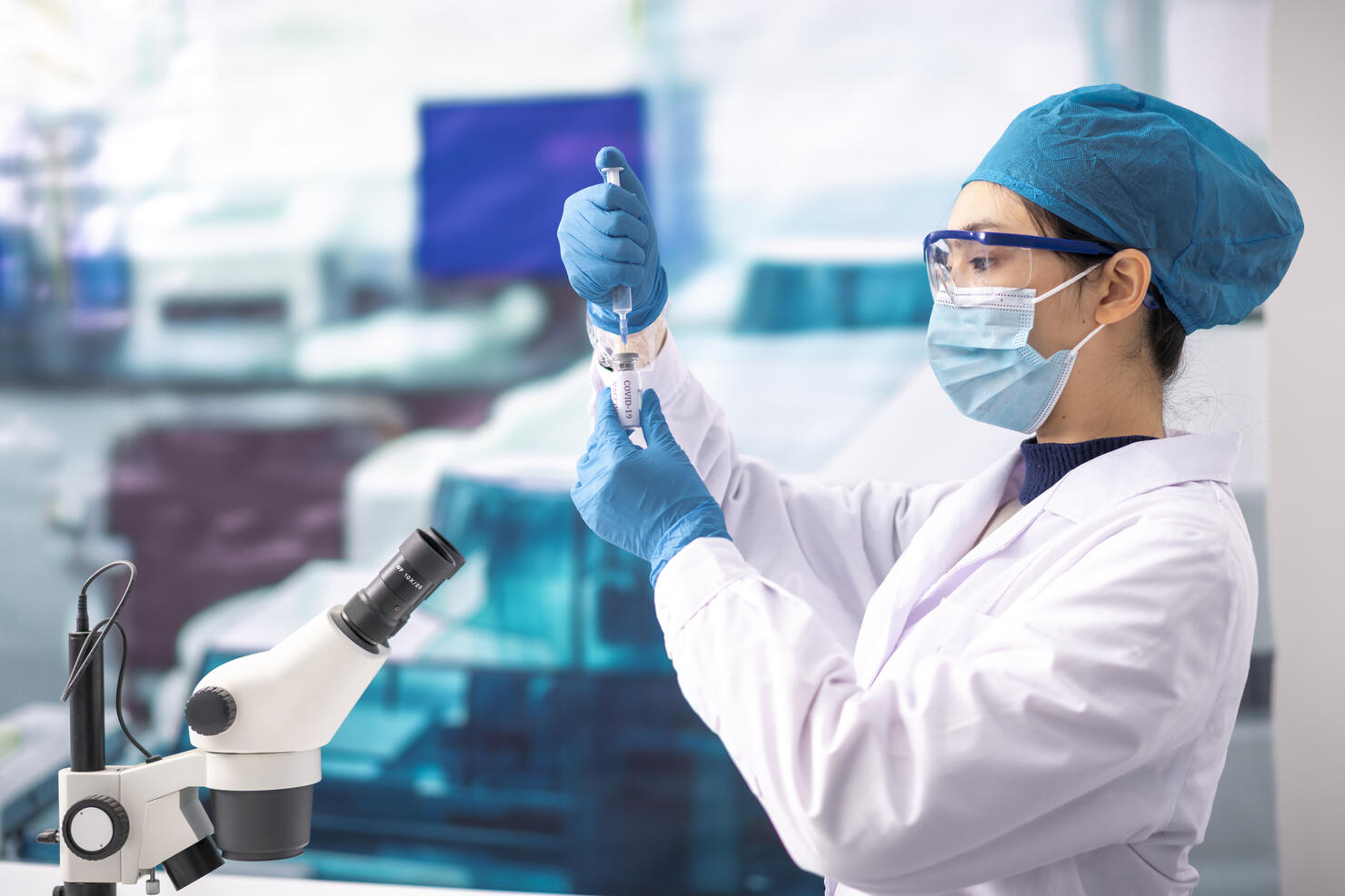 A young woman doctor studies the Covid-19 vaccine in the lab