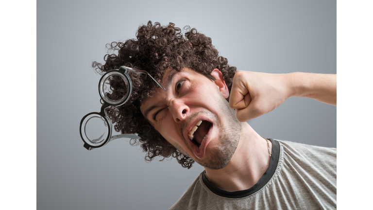 Funny man is getting punch in face with fist.