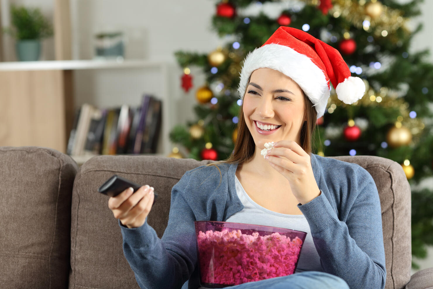 Woman watching christmas tv porgram at home
