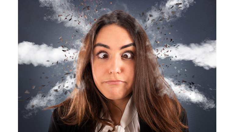 Businesswoman with head ready to explode due to stress and overwork