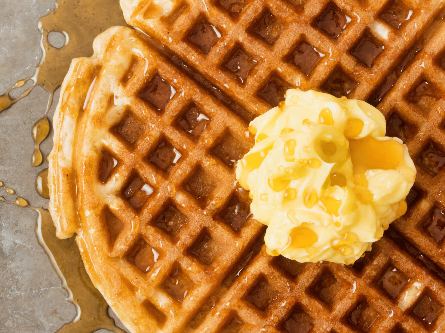 rustic traditional waffle with butter and maple syrup