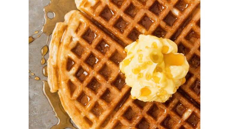 rustic traditional waffle with butter and maple syrup