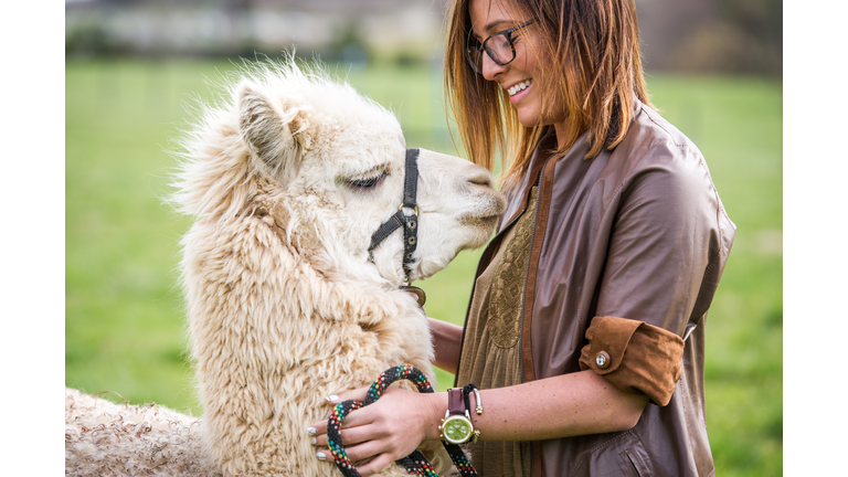 Young woman with an Alpaca