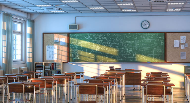 interior of a school classroom with wooden desks and chairs.