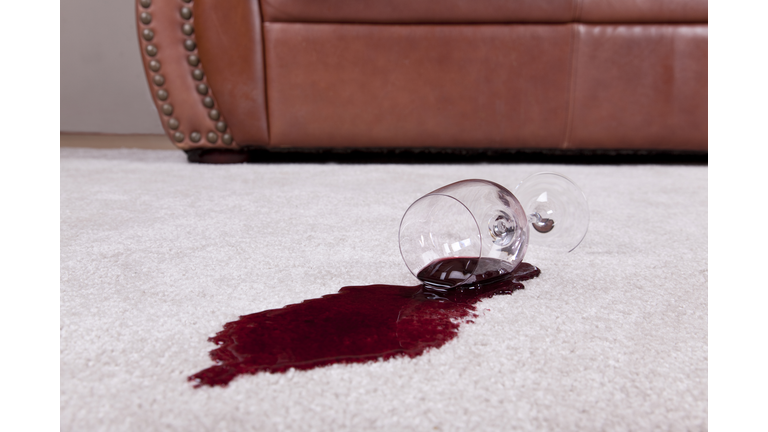 Spilled glass of wine on new carpet