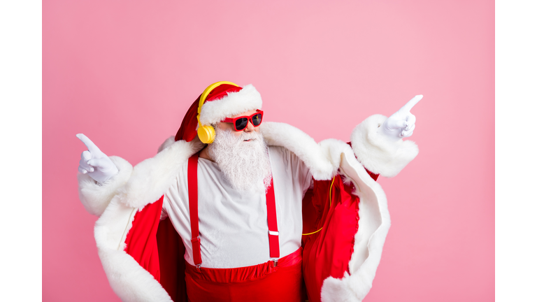 Photo of confident modern funky santa claus listen headphones x-mas christmas song stereo radio music dance wear sunglass suspenders headwear isolated over pastel color background