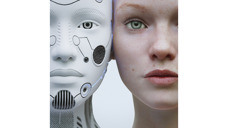 Female robot and human heads side by side