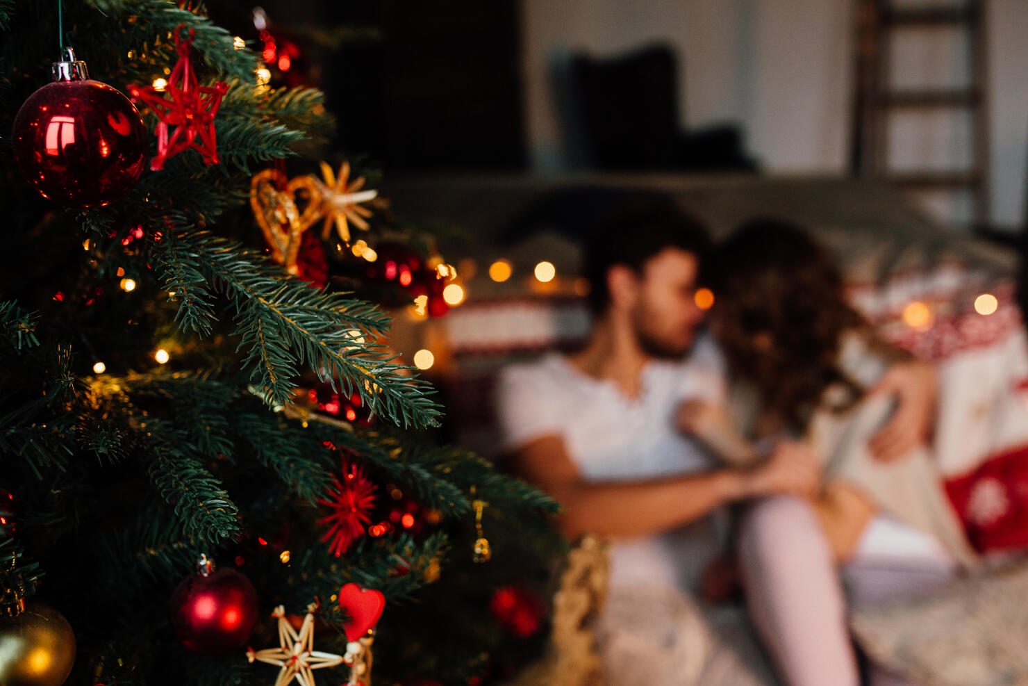 Couple in in pajamas resting on the floor next to