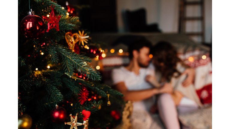 Couple in in pajamas resting on the floor next to