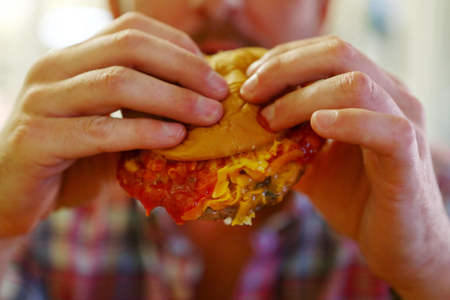 A Man Eating A Burger