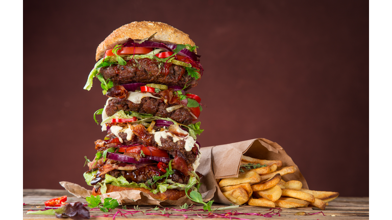 Tasty big burger on wooden table