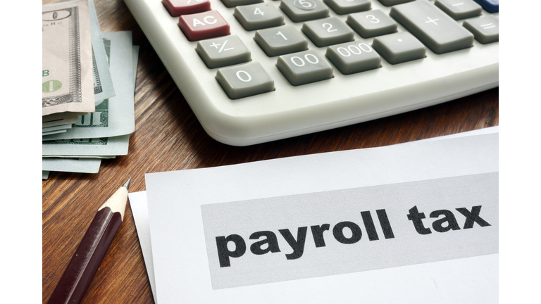 Payroll tax concept. Papers, calculator and money.