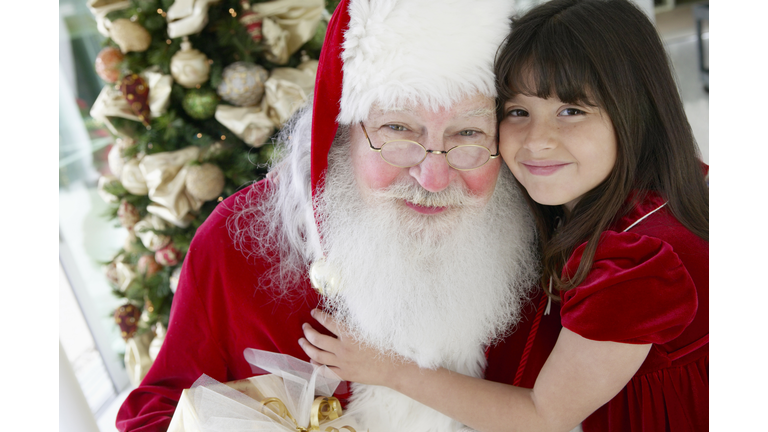 Portrait of a Young Girl With Her Arm Around Father Christmas