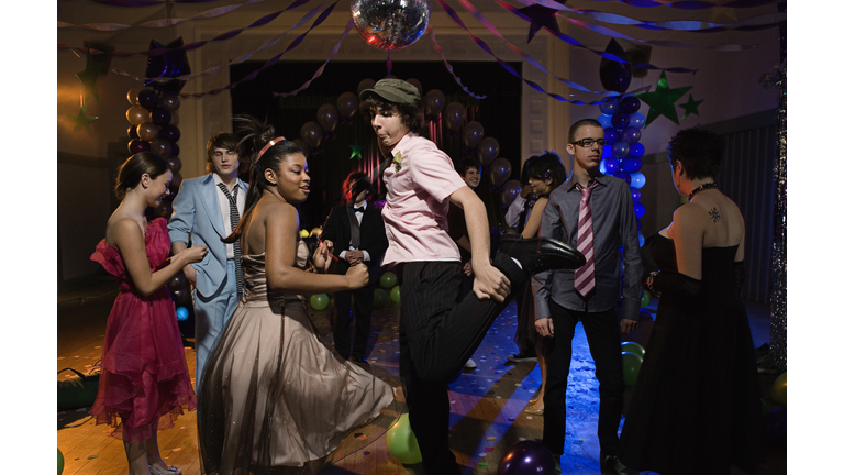 Teenagers dancing together at prom