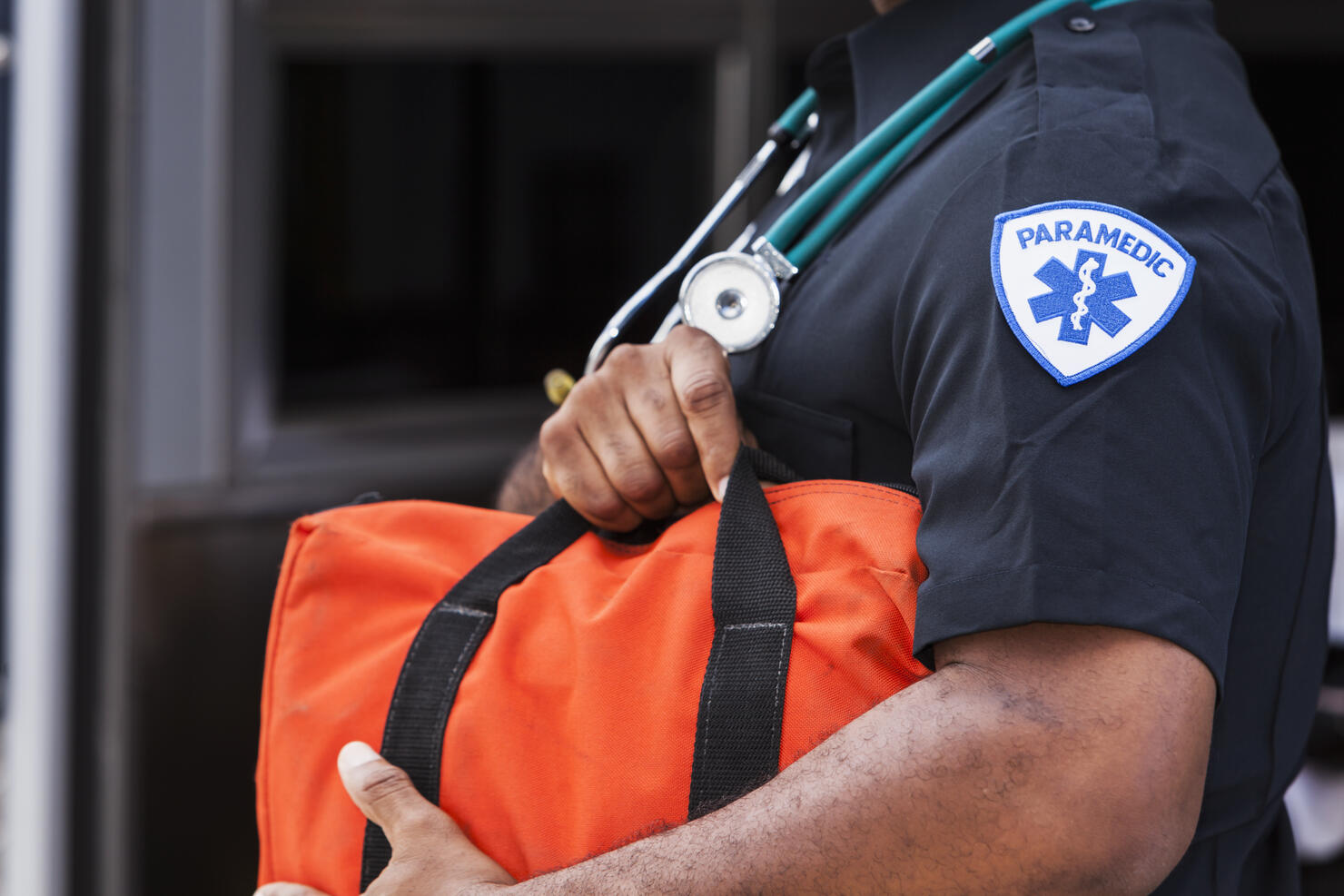 Paramedic holding medical bag