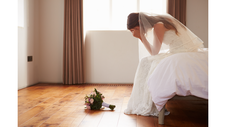Bride In Bedroom Having Second Thoughts Before Wedding