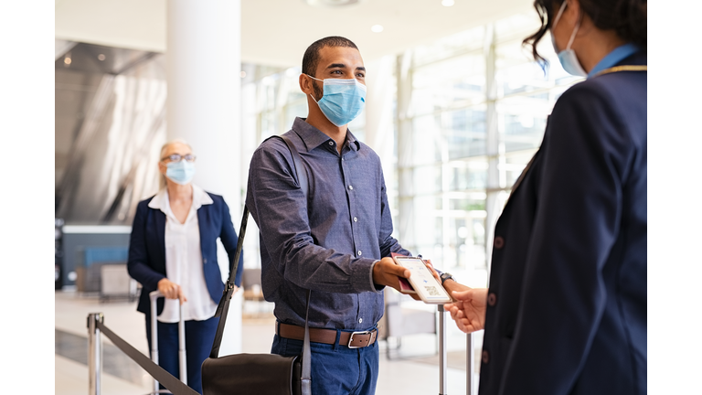 Passenger showing e-ticket at airport during covid pandemic