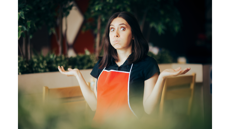 Clueless Puzzled Fast-Food Manager Standing in a Restaurant