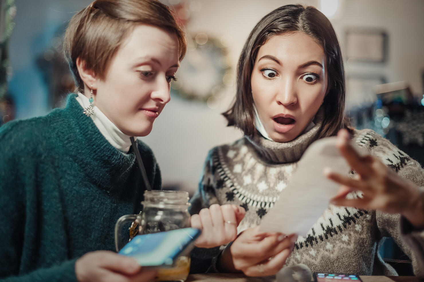 Asian woman stares at the check for dinner at the restaurant, her eyes bulging. The concept of inflation and devaluation of money and reduction of purchasing power of the population.