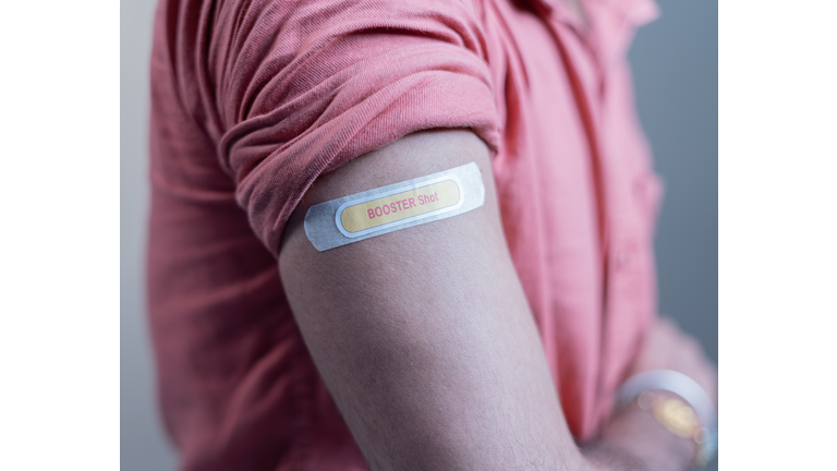covid-19 or coronavirus vaccinated shoulder with booster shot sticker - concept of coronavirus 3rd dose vaccination.