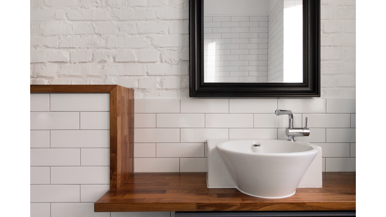 Interior of comfortable light bathroom with simple design