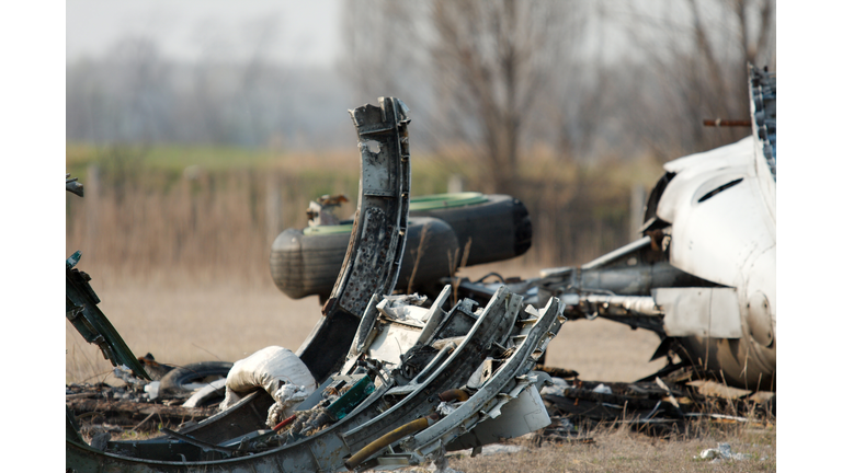 Plane wreckage and metal scraps in a field