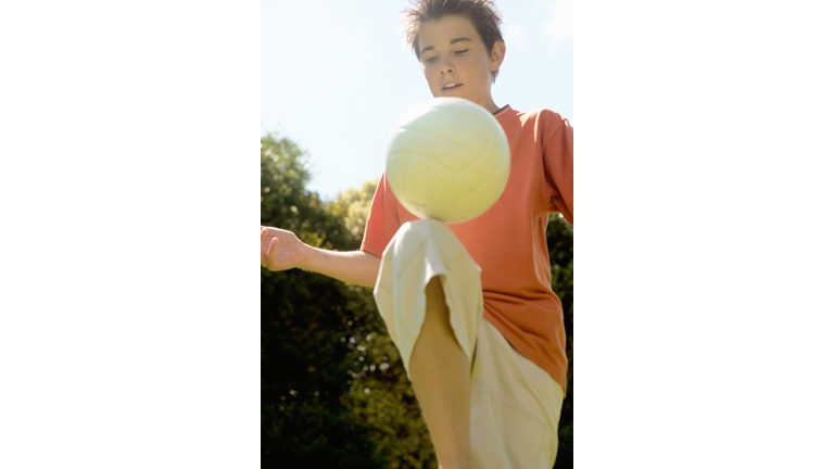 Boy playing with football