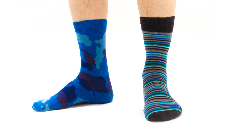 Man's Feet in Mismatched Socks, White Background
