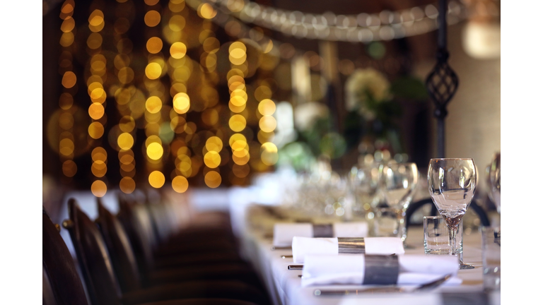 Formal wedding place setting on long table background