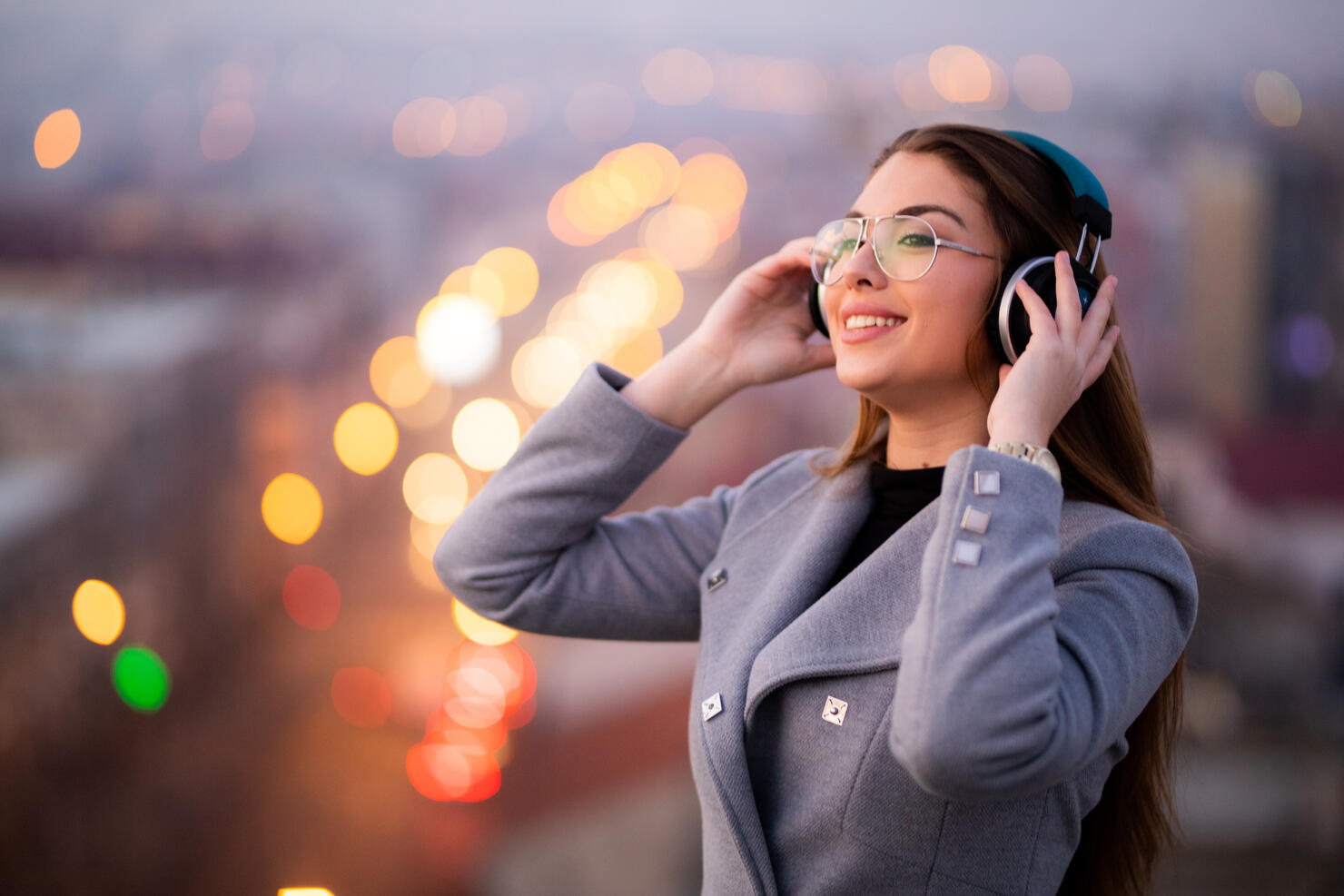 Beautiful young women listening to music on the rooftop