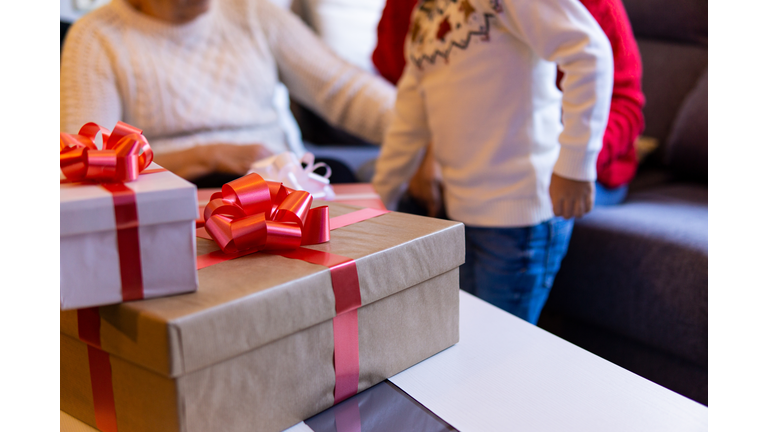 Family opening christmas presents. Close up view of the stack of gifts
