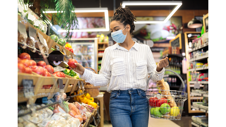 Black Woman Choosing Fresh Vegetables In Supermarket, Walking With Basket