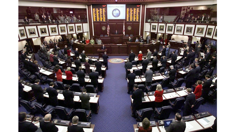 Members of the Florida House bow their heads in pr