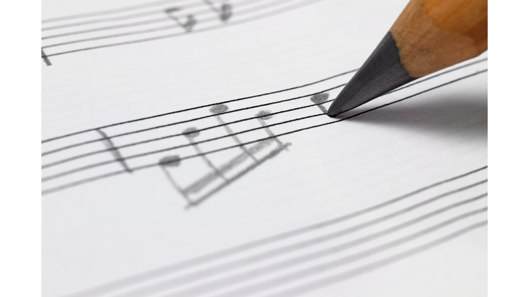 Close-up of writing a musical note