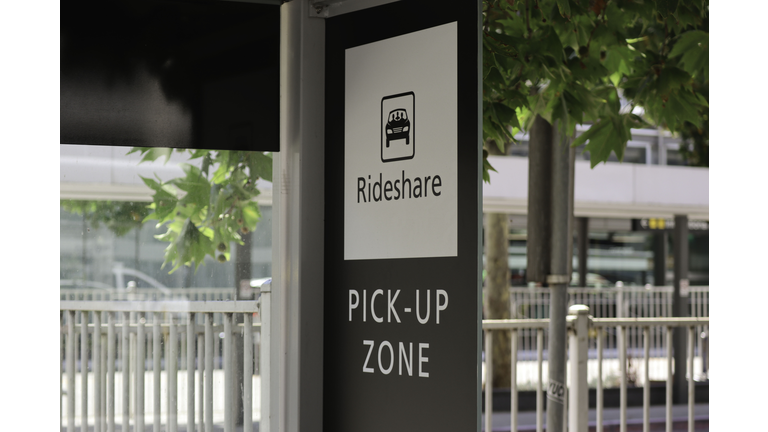 Black and white ride share pick-up zone sign