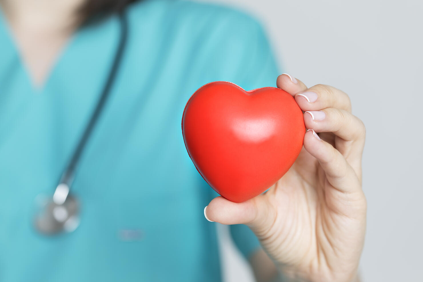 Doctor Holding Red Heart Shape in Hand
