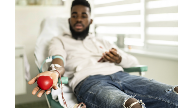 An african-american young man donating blood in the hospital