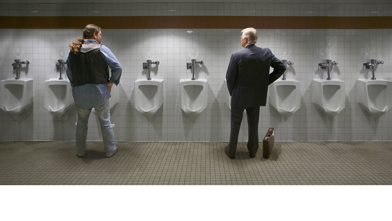 Two men standing at urinal, rear view (digital composite)