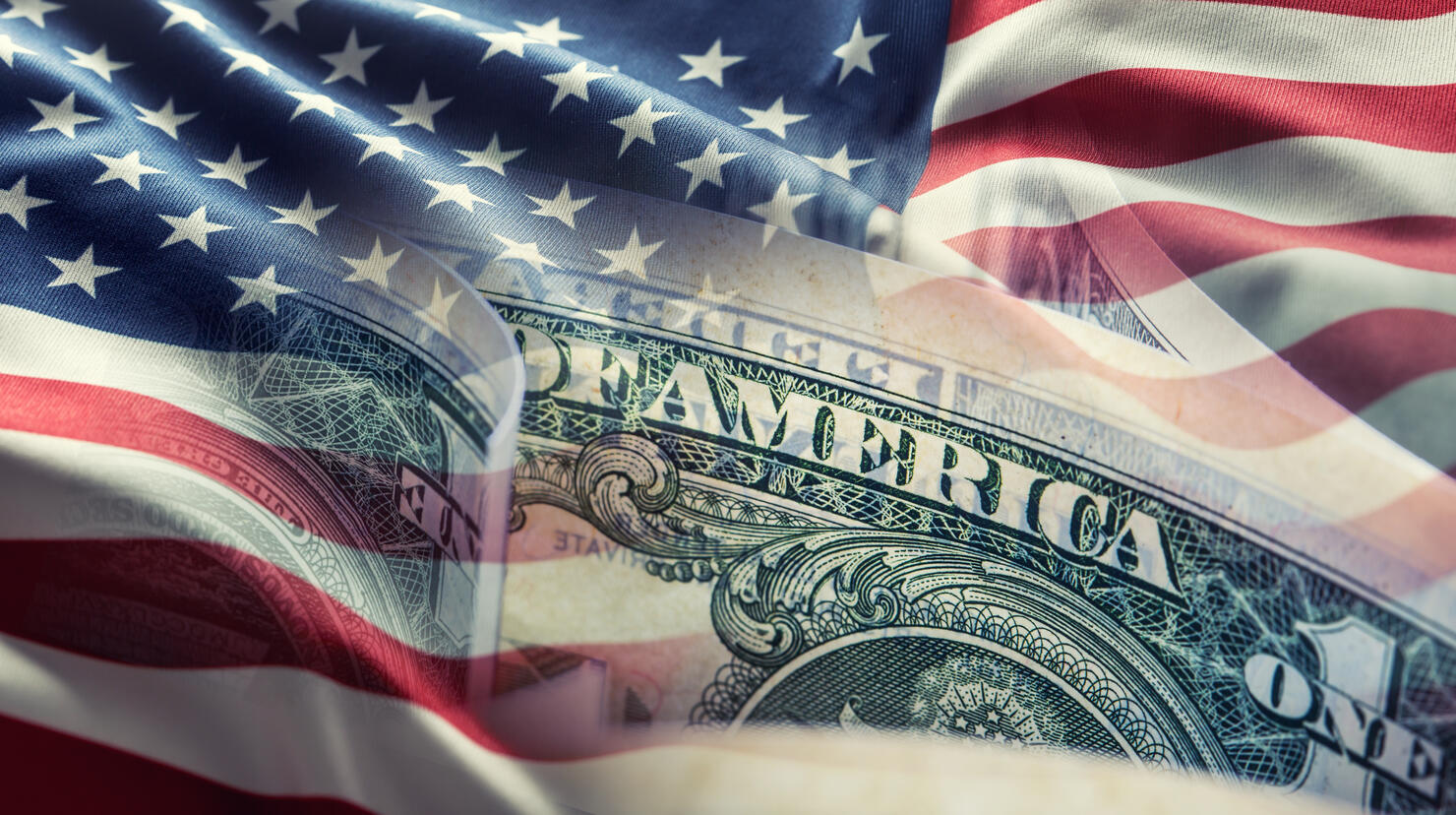American flag and dollar banknotes - business background.