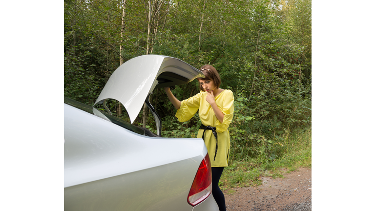 Young Woman  Looking in Trunk