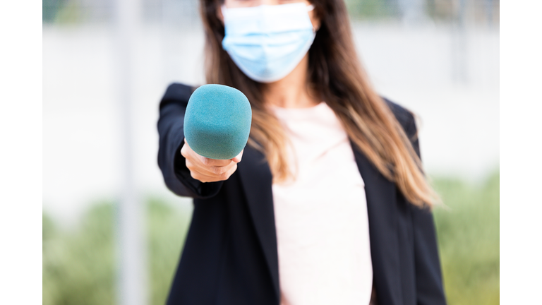 Journalist wearing a medical mask on the street - stock photo