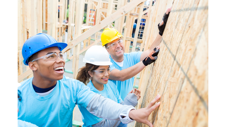 Confident volunteers build wall in charity home