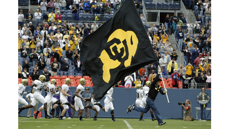 A Buffaloes fag is brought onto the field