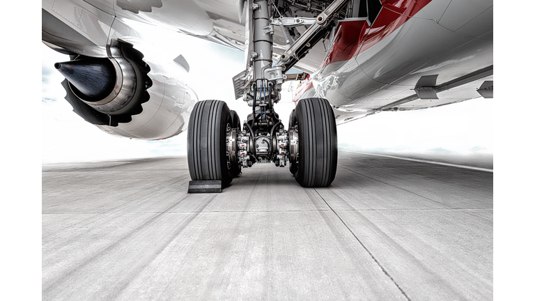 The huge wheels of the plane were parked on the runway of the airport