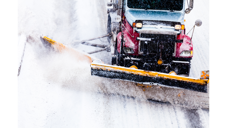 Snowplow removing the Snow from Highway during a Snowstorm